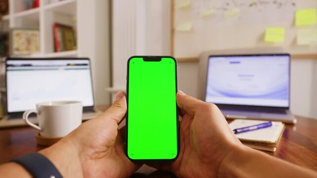 Phone with chroma key green screen, man working with chatbot AI online, connecting with AI and using a chat. High quality 4k footage