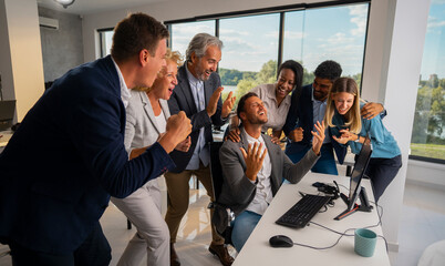 Diverse business professionals celebrating a significant achievement at the office, cheering and...