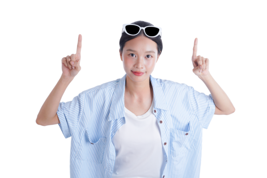 A Young Woman with Sunglasses Pointing Upwards: A young woman with sunglasses on her head is looking at the viewer, smiling and pointing her index finger up.