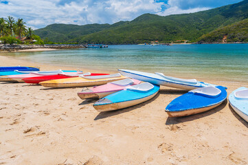 Kayaks on sandy beach by sea in lagoon in summer on vacation on a sunny day