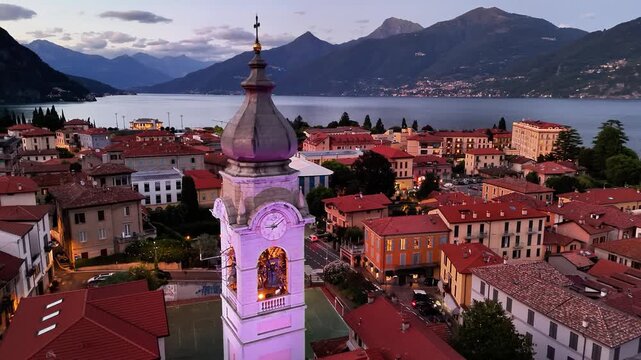 Explore Menaggio on Lake Como as the sun sets behind the mountains and the town lights up in a picturesque scene