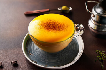Beautiful Vietnamese egg coffee in glass cup surrounded by spices inspiring educational curiosity and promoting cultural heritage through culinary art

