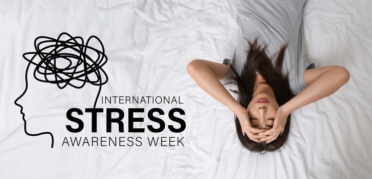 Young Asian woman with suicidal thoughts lying on bed. International Stress Awareness Week