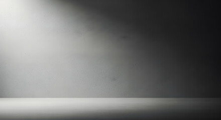 Dramatic spotlight illuminates an empty dark studio background, creating a gradient from bright white to deep grey, perfect for product photography or minimalist displays