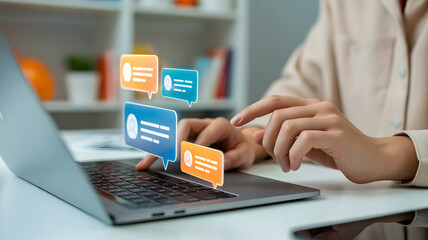 Woman using laptop with message bubbles, social media interaction and online communication