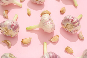 Composition with garlic on pink background