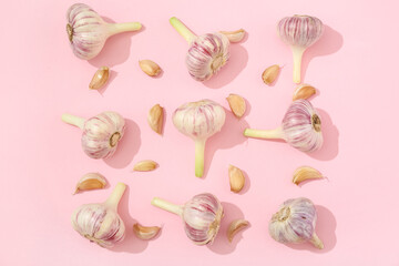 Composition with garlic on pink background