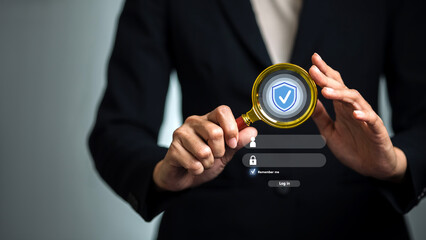 Businesswoman using magnifying glass to inspect login security, digital authentication and data protection concept