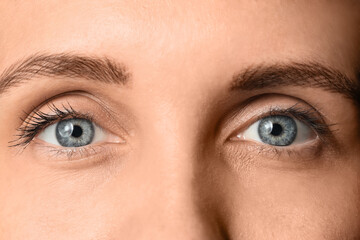 Obraz premium Beautiful young woman with long eyelashes and blue eyes, closeup