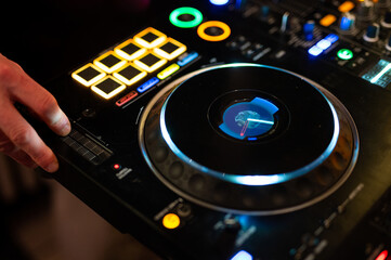 Obraz premium Professional DJ turntable jog wheel colorful LED nightclub equipment music mixing deck controller performance
