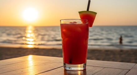 Red drink with watermelon wedge  black straw sits on a table beach sunset background