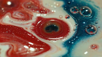 a close up of a red, white and blue liquid with bubbles - Powered by Adobe