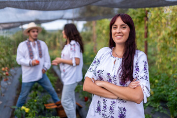 Woman smiling in traditional romanian blouse at garden house