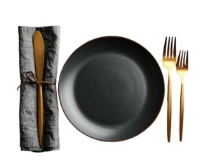 Elegant table setting black plate, gold cutlery, and a rolled cloth napkin against a dark backdrop