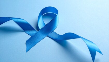 A blue ribbon symbolizing Movember prostate cancer awareness against a light blue background with subtle shadows.