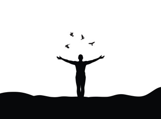 Silhouette of a person releasing birds into the sky