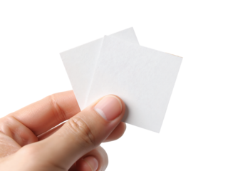 Holding two small white square papers