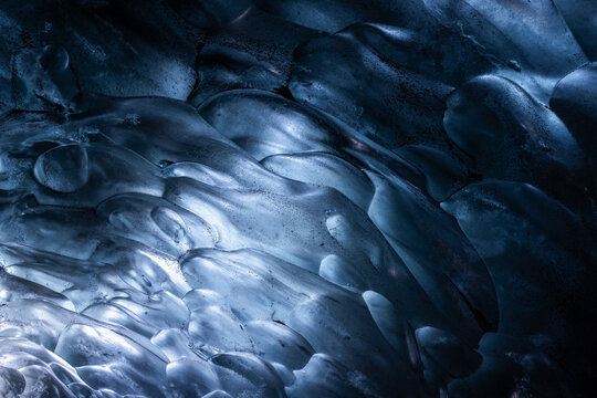 Blue frozen abstract ice bubbles in an ice cave in Iceland