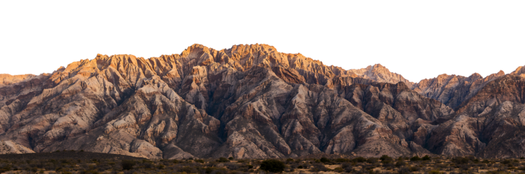Dramatic Mountain Range at Sunset with Jagged Peaks and Golden Light Revealing Textured Rock Formations against Dark Background