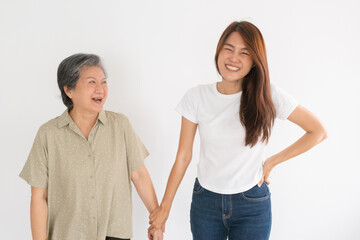 Happy Asian Thai granddaughter and grandmother holding hands and laughing together, isolated over white background