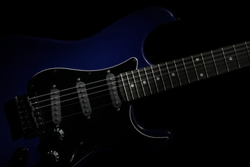 Modern electric guitar on black background