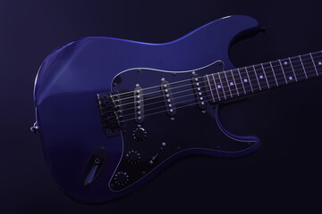Obraz premium Modern electric guitar on blue background