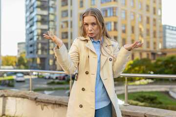 Doubtful frustrated mature businesswoman shrugging shoulders dont know answer incertitude gesture...