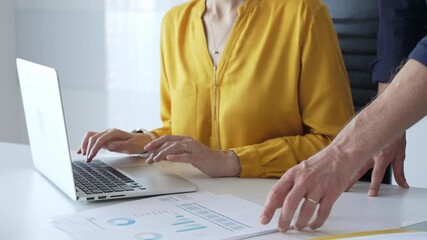 Business team reviewing financial data on laptop, analyzing charts and strategizing corporate workflow, collaborating toward shared business objectives. Business people - Powered by Adobe