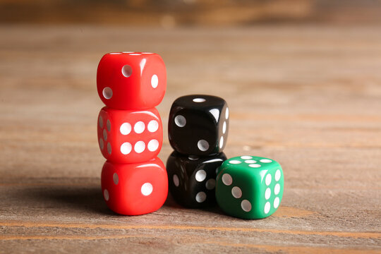 Colorful dices on wooden background