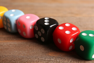Colorful dices on wooden background