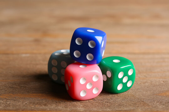 Colorful dices on wooden background