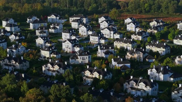 Aerial drone view of luxury home enclave in autumn landscape at sunrise