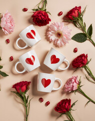 Romantic Valentine’s Day Flat Lay with Red Heart Ceramic Mugs and Fresh Flowers on Beige Background, Cozy Warm Lifestyle Scene