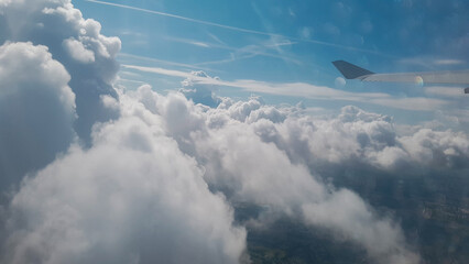 Fototapeta premium Flying among the clouds, view from the airplane window