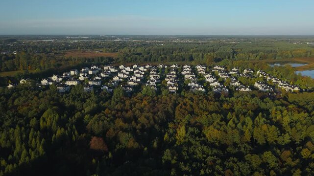 Aerial drone view of luxury home enclave in autumn landscape at sunrise