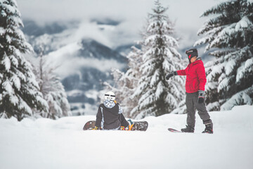 Two snowboarders before a ride