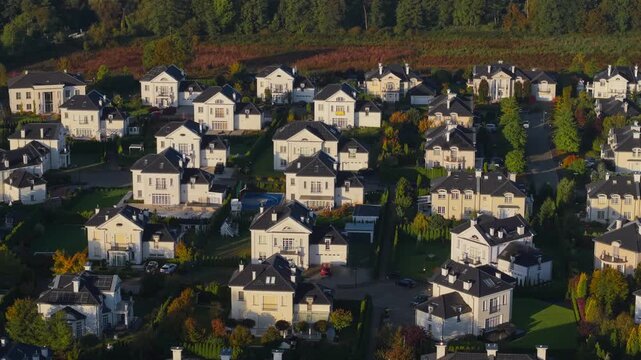 Aerial drone view of luxury home enclave in autumn landscape at sunrise
