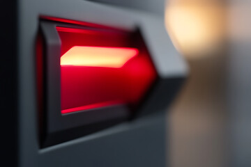 Illuminated security scanner with a stark red light, modern technology, high-tech aesthetics, and a futuristic feel, captured in a close-up shot.