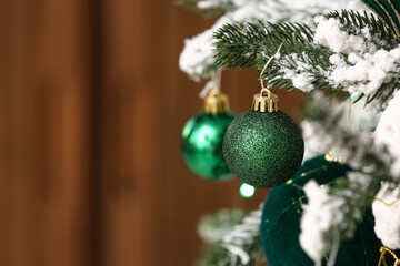 Balls hanging on Christmas tree against blurred background