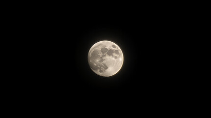Obraz premium A glowing full moon captured in a black night sky, representing beauty of nature, astronomy, and the mystery of the cosmos