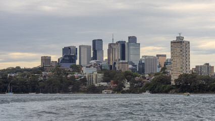 Obraz premium Residential Houses and apartment buildings on Parramatta River Sydney Harbour on a warm spring cloudy overcast day in Sydney NSW Australia 