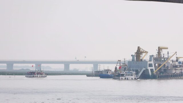 Fshing boats heading out to sea from the coastal port in Binhai, Tianjin, China.