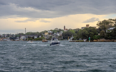 Obraz premium Residential Houses and apartment buildings on Parramatta River Sydney Harbour on a warm spring cloudy overcast day in Sydney NSW Australia 