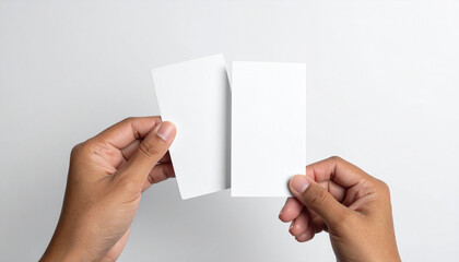 Person holding two blank white cards hand