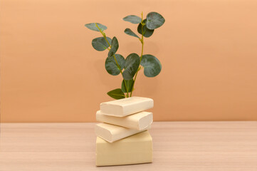 White natural handmade soap with eucalyptus on a beige background.