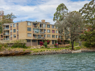 Residential Houses and apartment buildings on Parramatta River Sydney Harbour on a warm spring cloudy overcast day in Sydney NSW Australia 