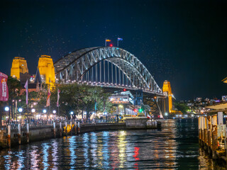 Harbour Bridge at Circular Quay on Sydney Harbour illuminated at night on a spring cool night in Sydney NSW Australia