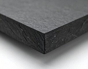 Close up of a dark textured stone surface with rough edges.