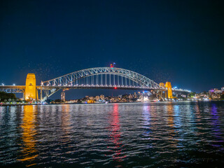 Harbour Bridge at Circular Quay on Sydney Harbour illuminated at night on a spring cool night in Sydney NSW Australia