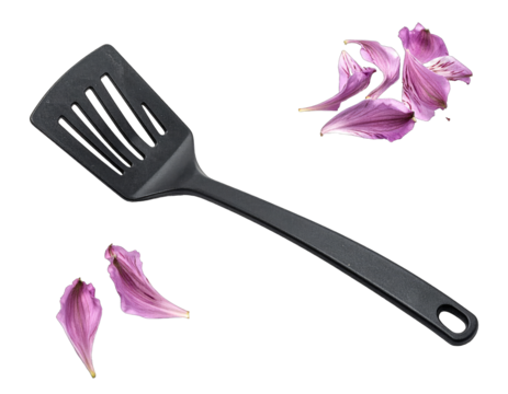 Black spatula and fallen pink petals on a black background - Powered by Adobe